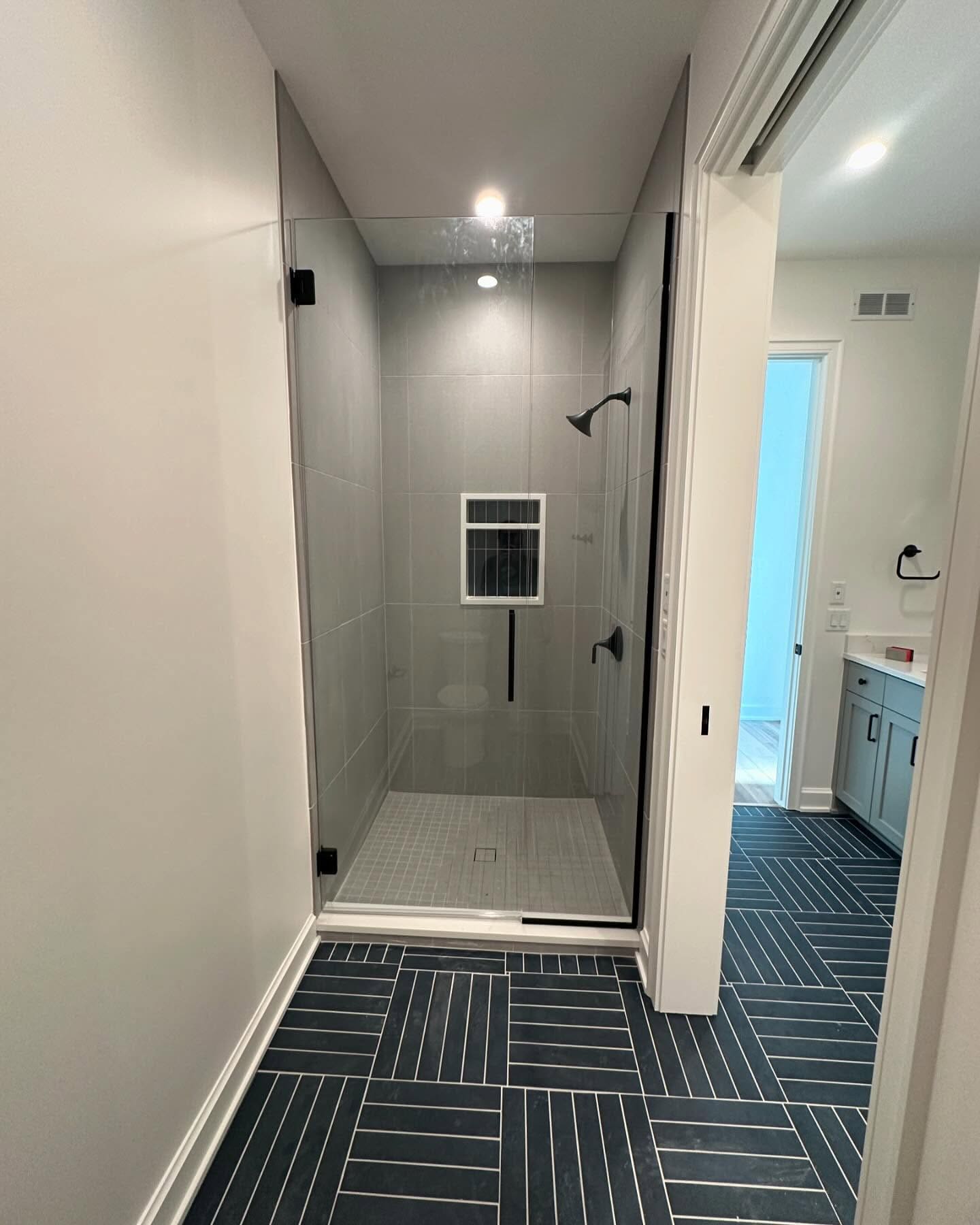 Herringbone tile floor in a custom shower